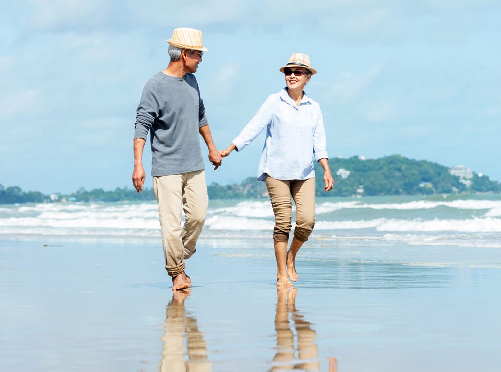 People holding hands on a beach